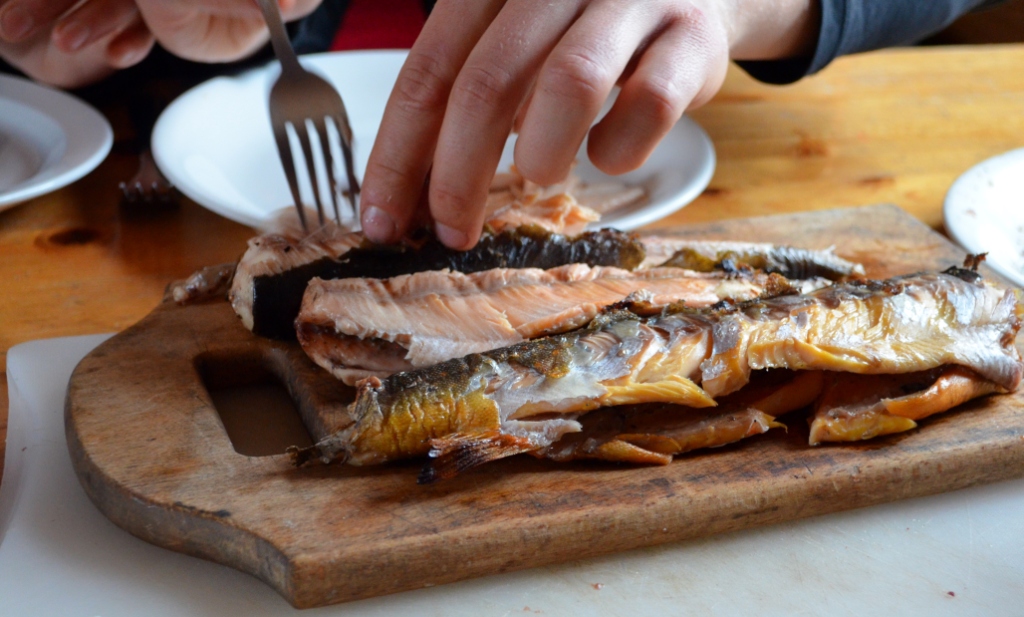 Roding (arctic char) roasted over a wood fire.